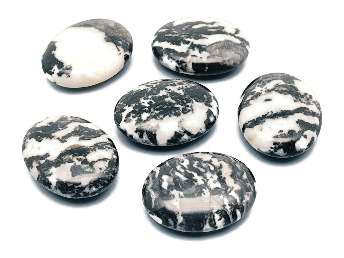 Zebra Calcite Palm Gemstone spa stone, 45x35mm, showcasing black and white striped patterns, suitable for meditation or relaxation.