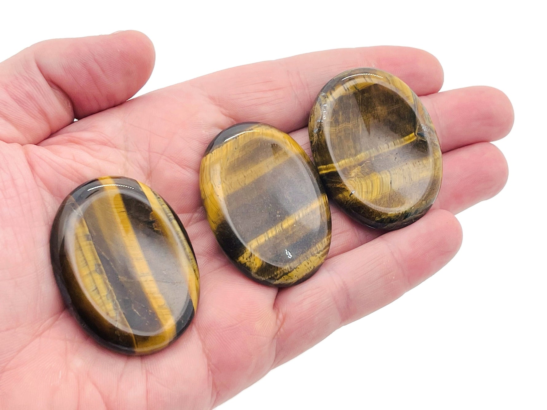 Tiger Eye worry stone from GemstoneGO, smooth 4.5x3.5cm crystal for stress relief and soothing handheld meditation.