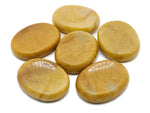 Yellow Jade worry stone from GemstoneGO, soothing crystal with smooth surface, measuring 4.5x3.5cm, ideal for stress relief and meditation.
