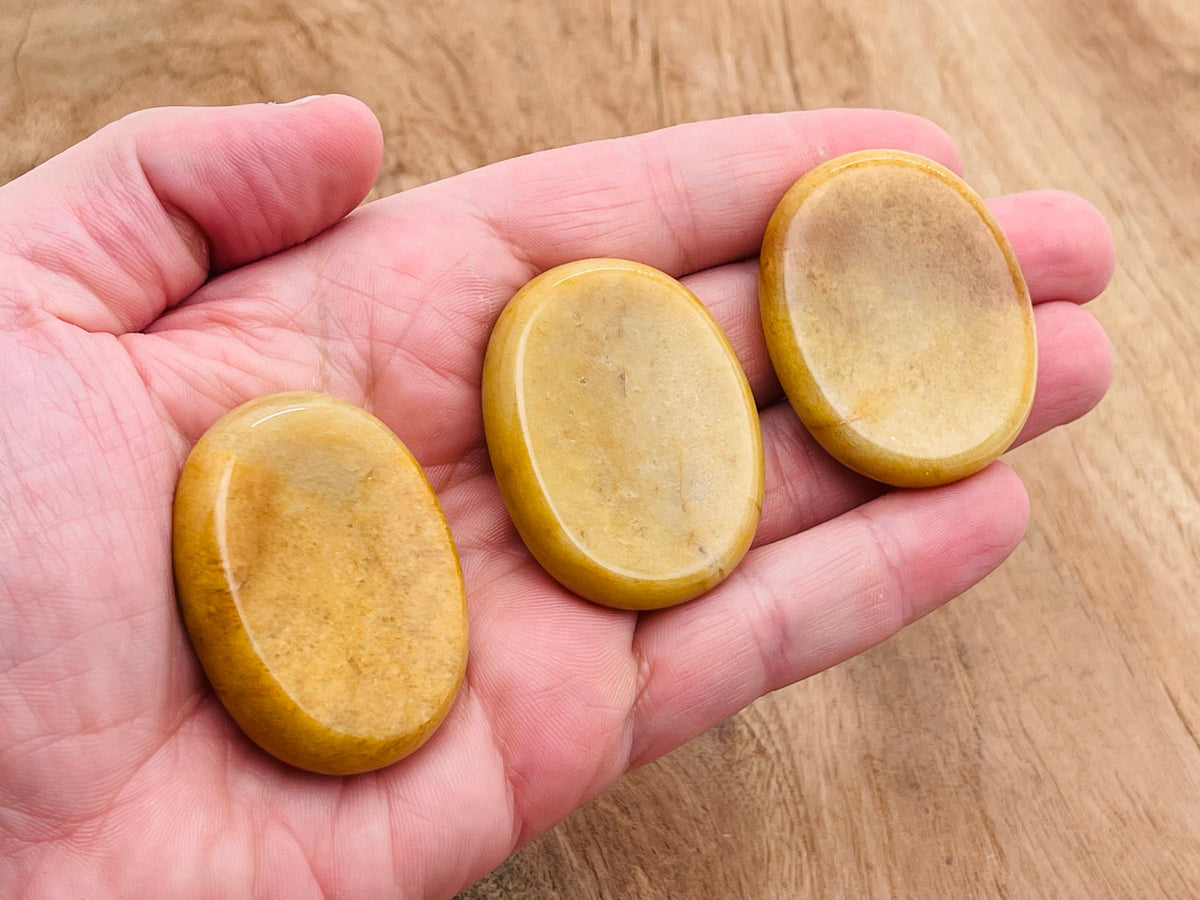 Yellow jade worry stone from GemstoneGO showing a 4.5x3.5cm smooth, polished crystal for stress relief and soothing tactile experience.