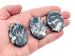 Zebra Calcite worry stone from GemstoneGO, smooth 4.5x3.5cm crystal with black and white striped pattern for soothing grip.