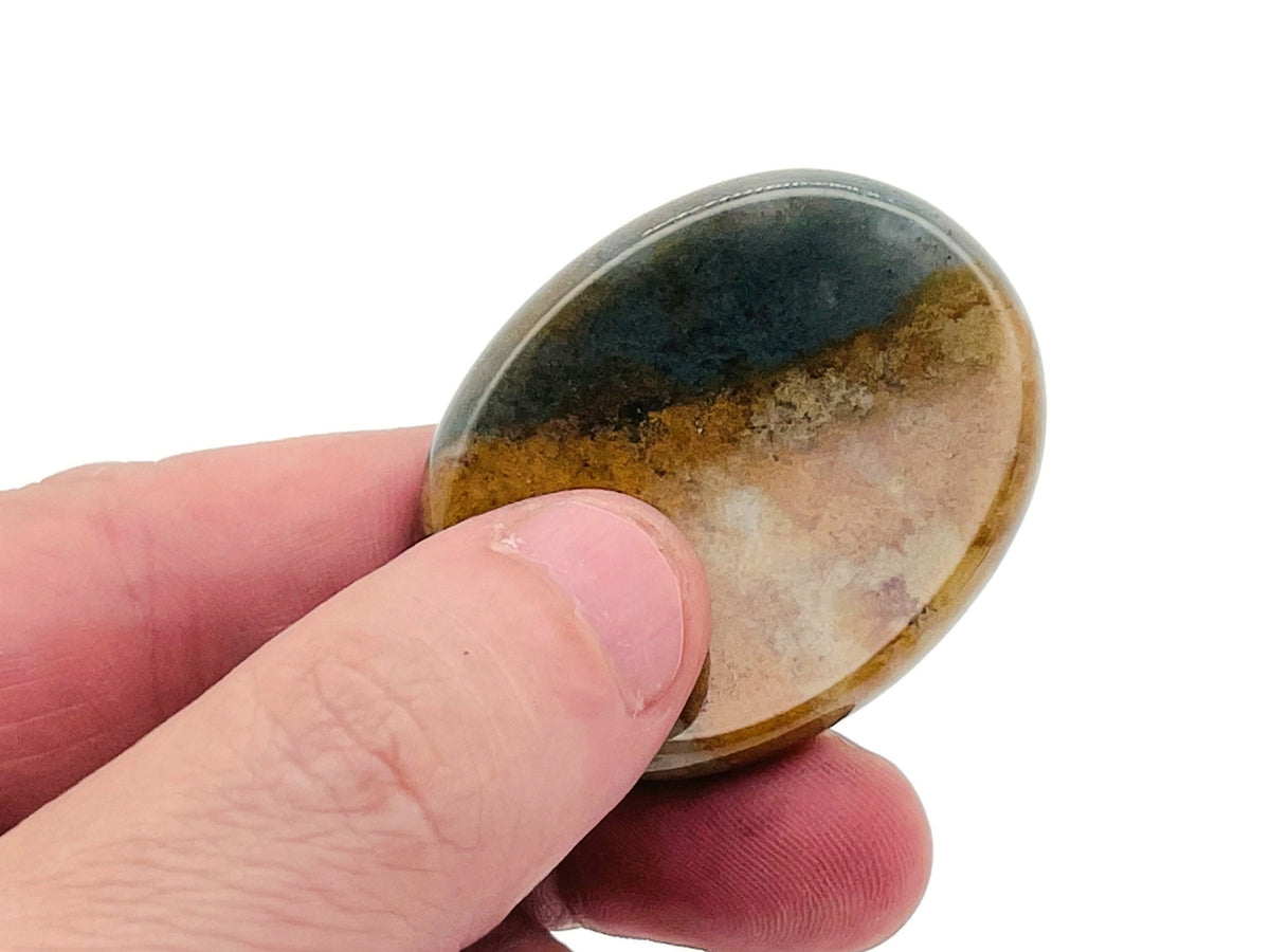 Moss Agate worry stone from GemstoneGO, soothing crystal with green and brown patterns, measuring 4.5x3.5cm on a white background.