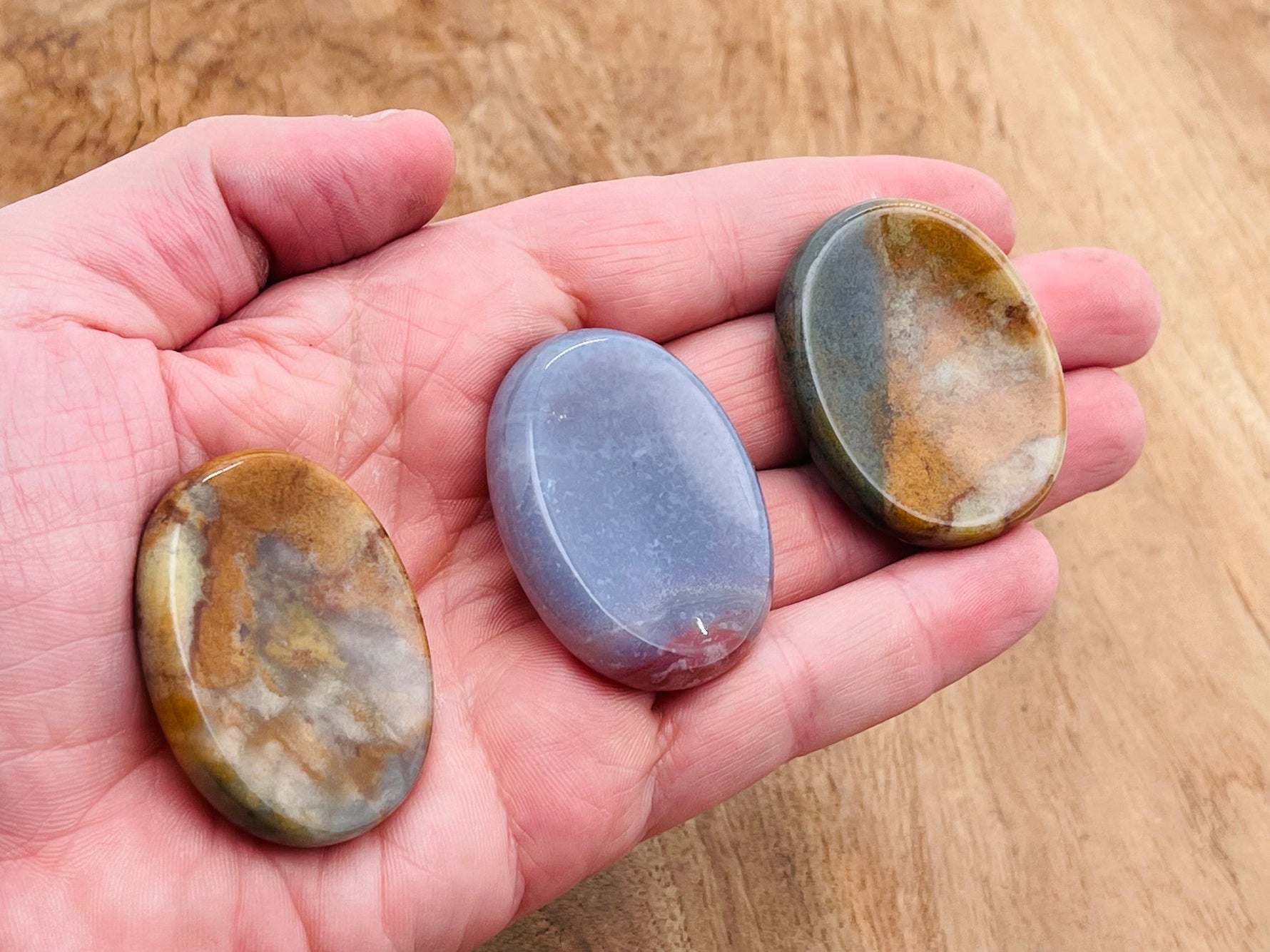 Moss agate worry stone from GemstoneGO, 4.5x3.5cm, featuring natural green and brown patterns, smooth polished crystal for soothing use.