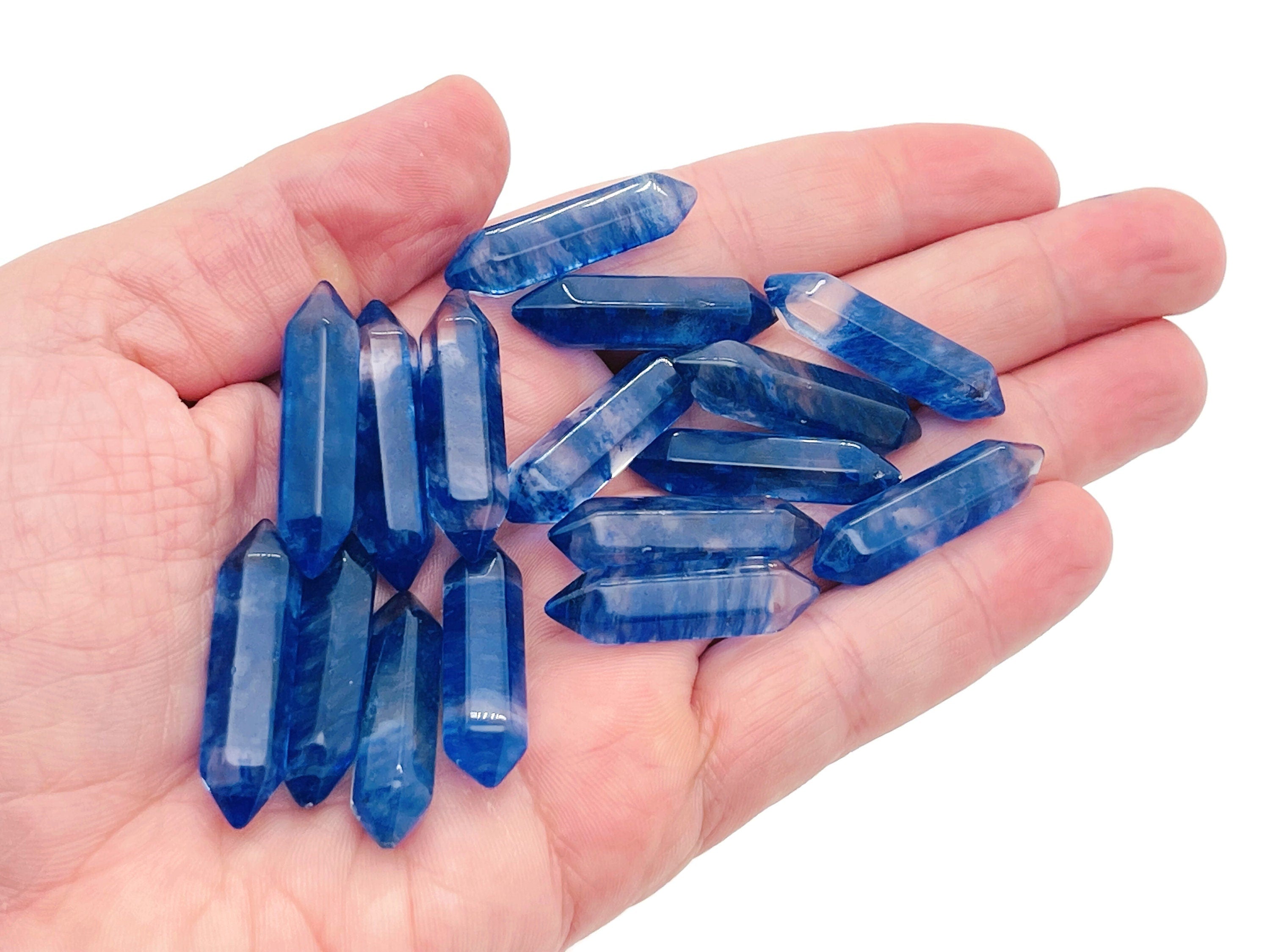 Blue Quartz terminated carved point gemstone from GemstoneGO, 33mm, featuring a polished, pointed crystal with natural blue color.