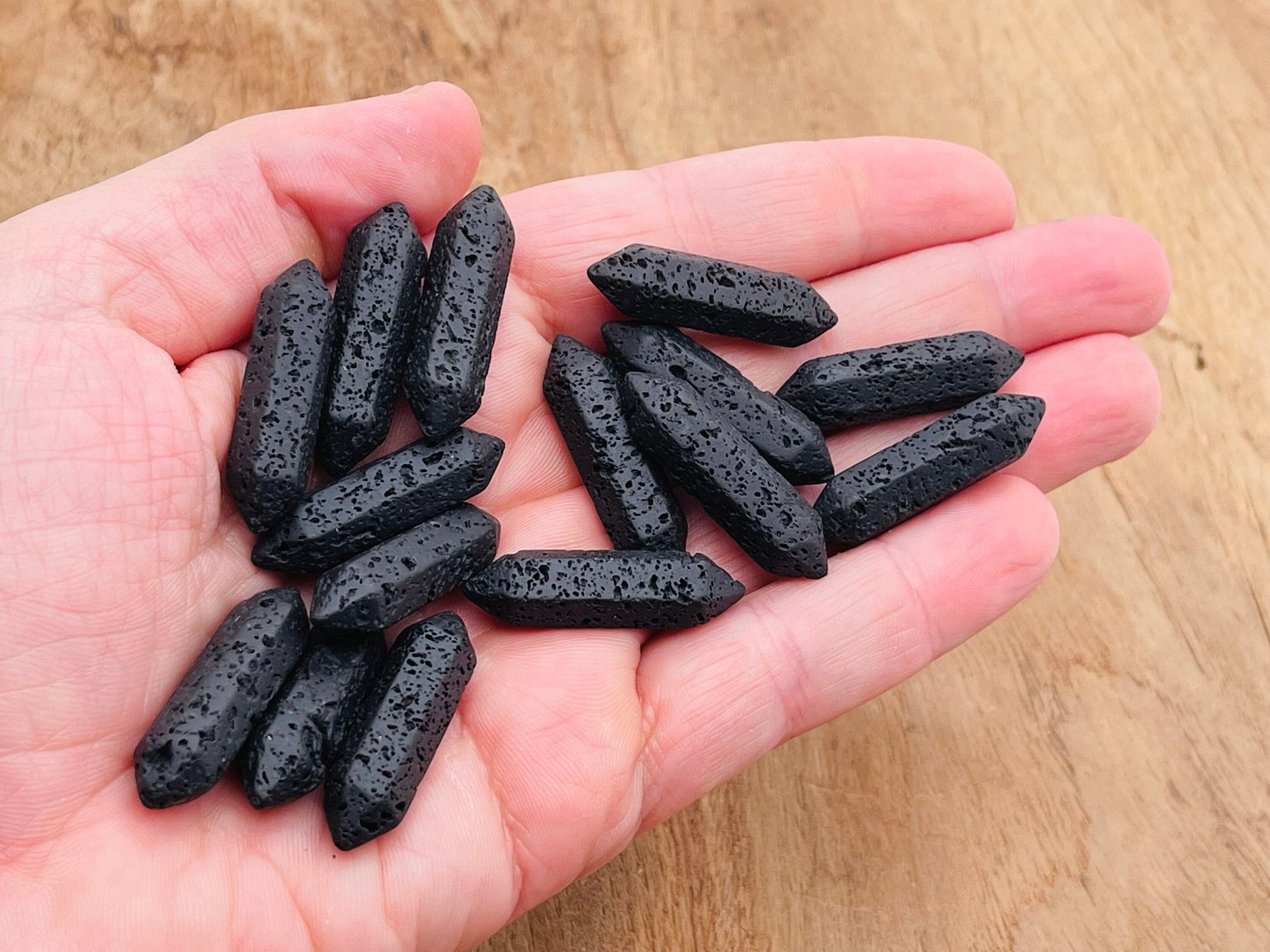 Lava volcanic terminated carved point gemstone, 33mm, with natural textures and deep black color, from GemstoneGO.