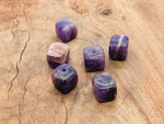 Handmade amethyst crystal incense holder with carved design, perfect for holding incense sticks and adding a natural gemstone touch.