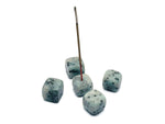Handmade Kiwi Jasper crystal incense holder with carved design, perfect for holding incense sticks in a natural gemstone display.