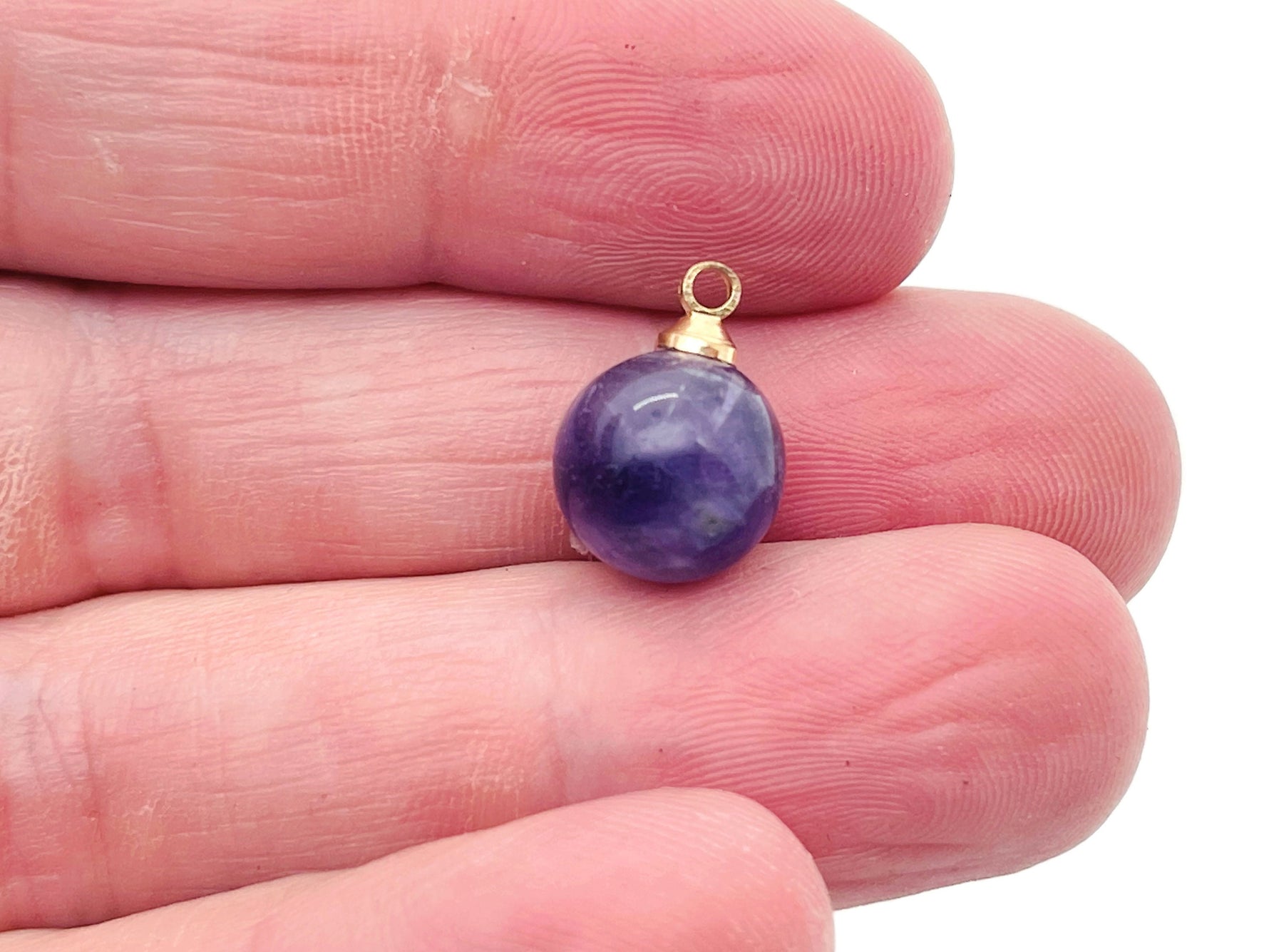 Amethyst ball beads crystal pendant jewelry with purple gemstone, showcasing smooth, polished amethyst stone on a jewelry display.