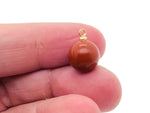 Red Jasper ball bead crystal pendant with gemstone jewelry stone, showcasing a polished red jasper sphere on a simple jewelry setting.