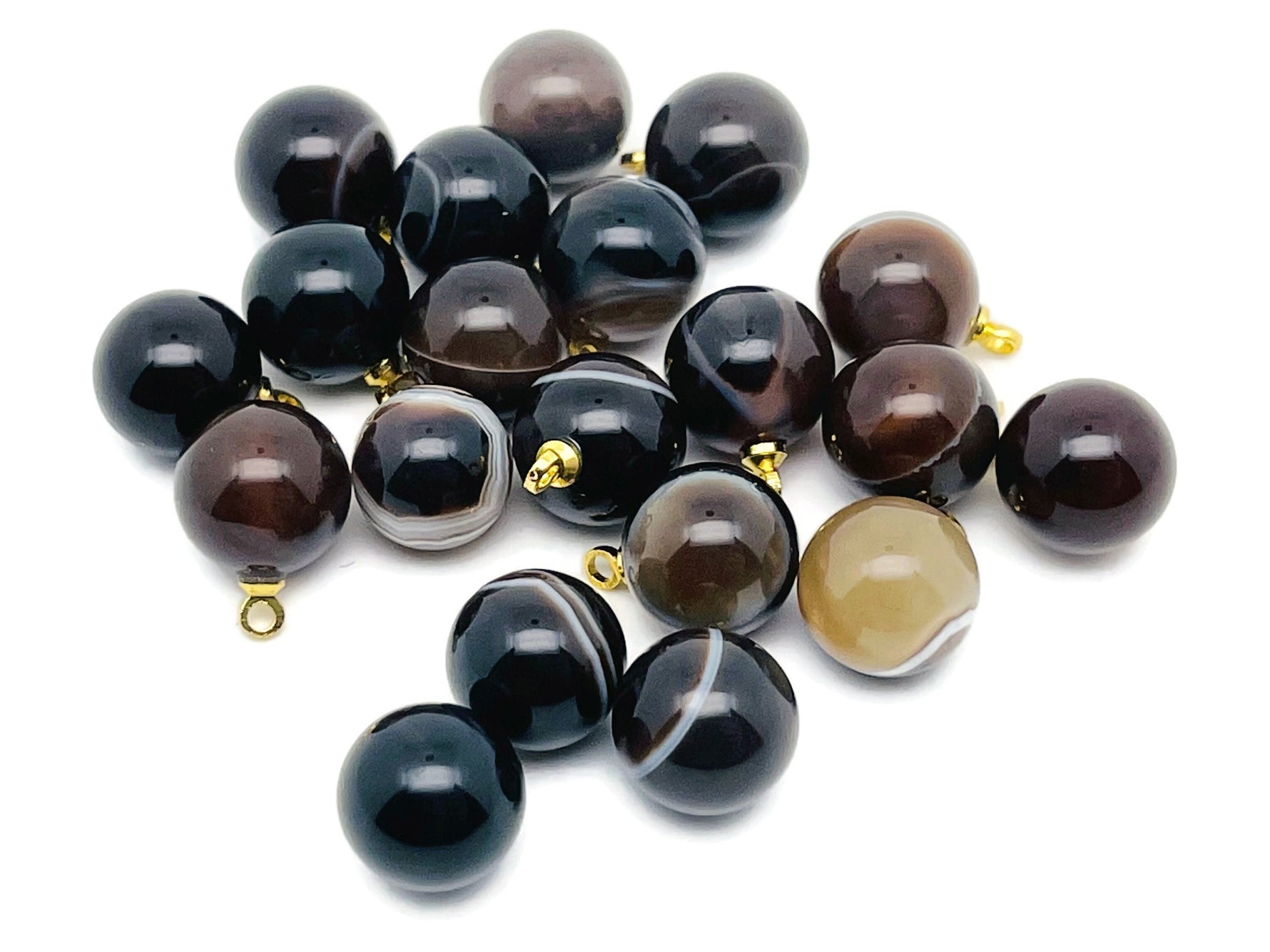 Black agate ball beads with crystal pendant from GemstoneGO, showcasing polished jewelry stones and elegant pendant detail.