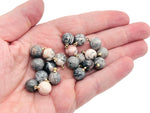 Pink Zebra Calcite ball beads crystal pendant from GemstoneGO, showcasing smooth pink and white gemstone jewelry stone.