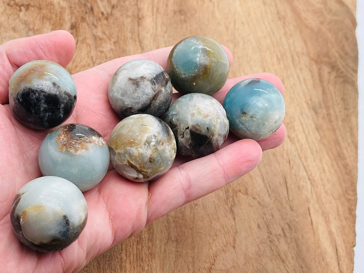 30mm Caribbean Calcite gemstone sphere, crystal ball, from GemstoneGO, showcasing a smooth, polished natural mineral with vibrant colors.