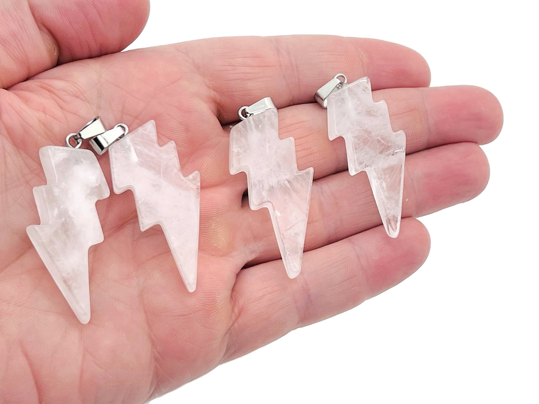 Rose quartz lightning crystal pendant from GemstoneGO featuring a polished pink quartz stone with silver-tone setting.