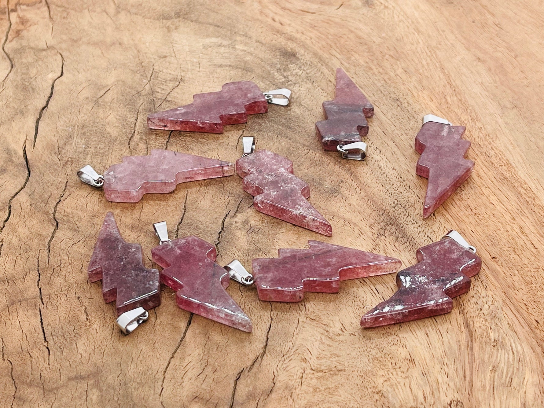 Strawberry Quartz Lightning Crystal Pendant featuring a vibrant pink gemstone and lightning-shaped silver setting from GemstoneGO.