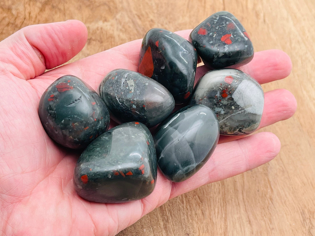 African Bloodstone tumbled gemstone from GemstoneGO, showing a polished dark green stone with red blood-like inclusions.