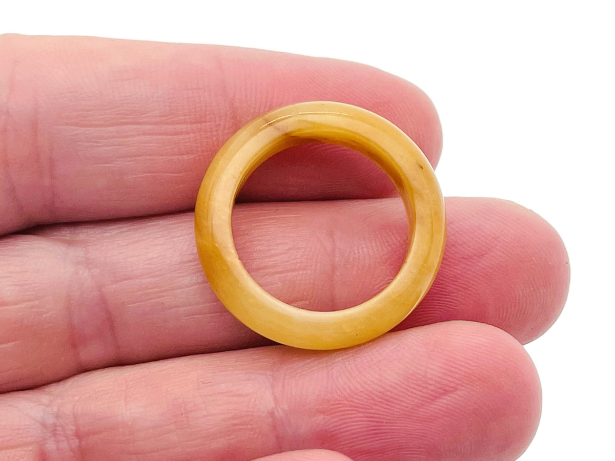 Yellow aventurine crystal ring from GemstoneGO featuring a polished yellow gemstone set in a silver band.