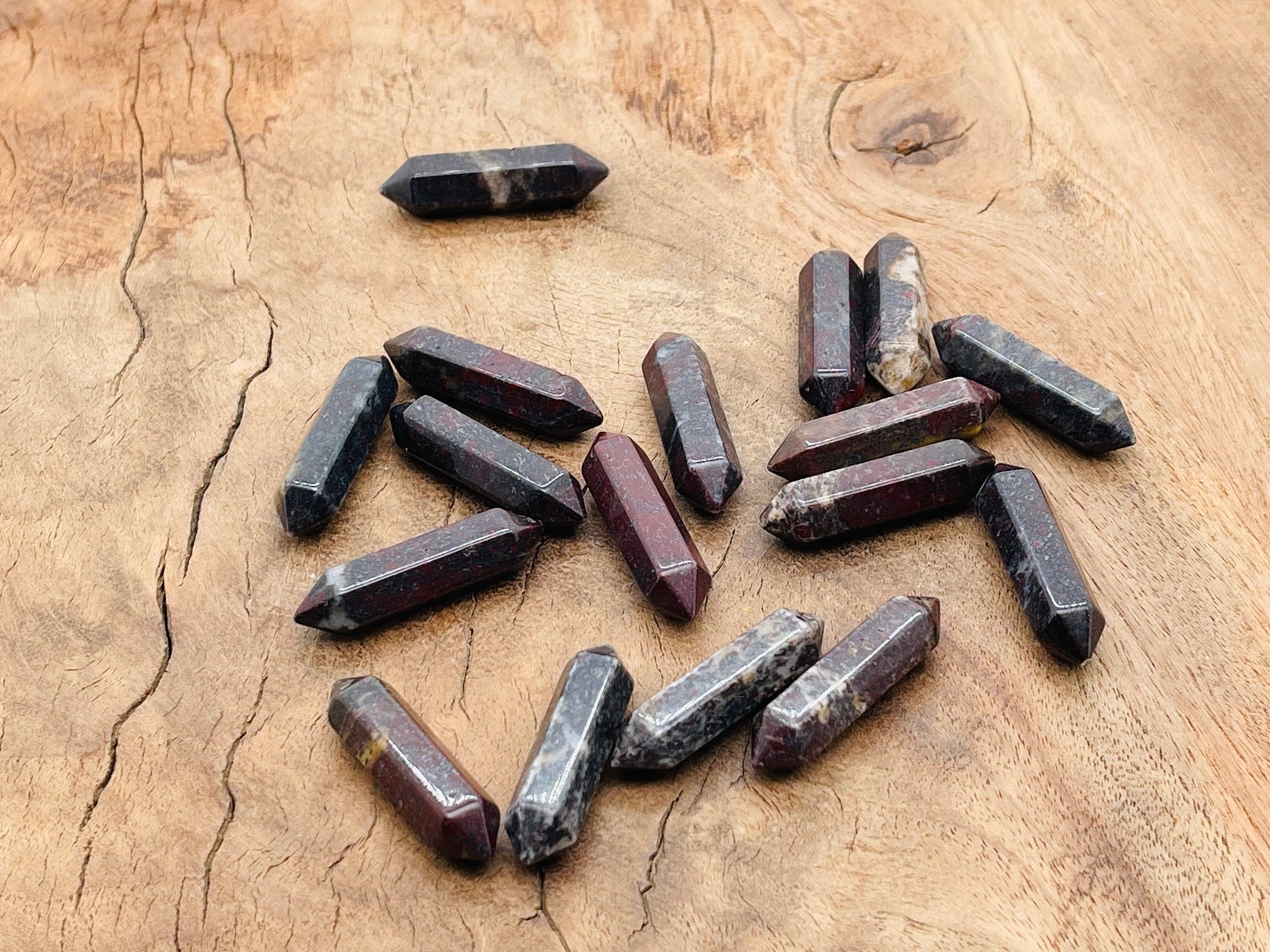 Dragon Blood Jasper carved terminated point, 33mm, from GemstoneGO, showcasing vibrant red and black mineral patterns.
