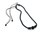 Obsidian sphere crystal pendant necklace with cord, featuring a polished black gemstone for healing and spiritual energy.