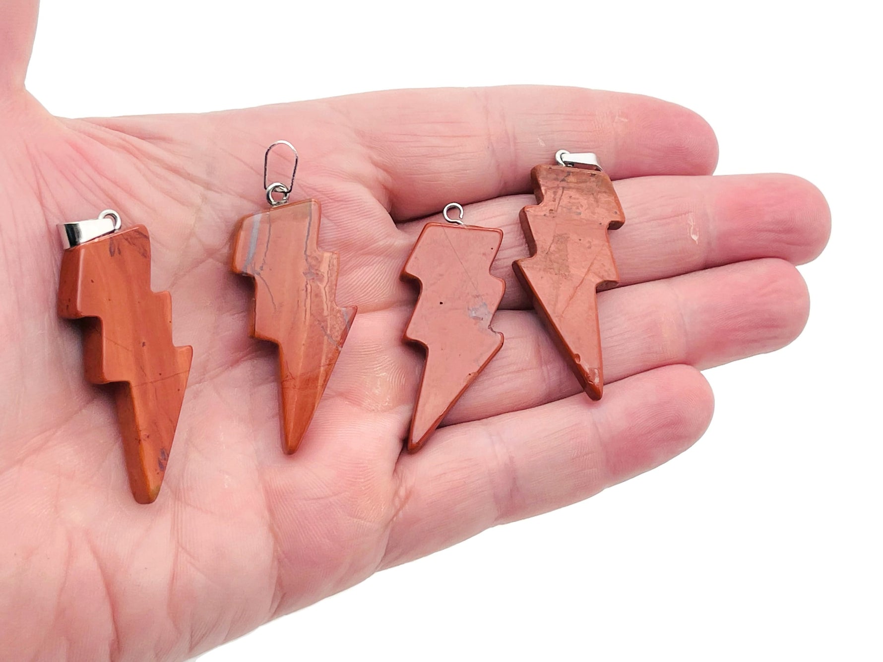 Red Jasper Lightning Crystal Pendant from GemstoneGO featuring a striking lightning-shaped red jasper stone necklace.