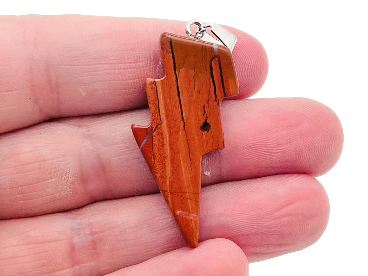 Red Jasper Lightning Crystal pendant from GemstoneGO featuring a vibrant red jasper stone with lightning-like crystal accents.