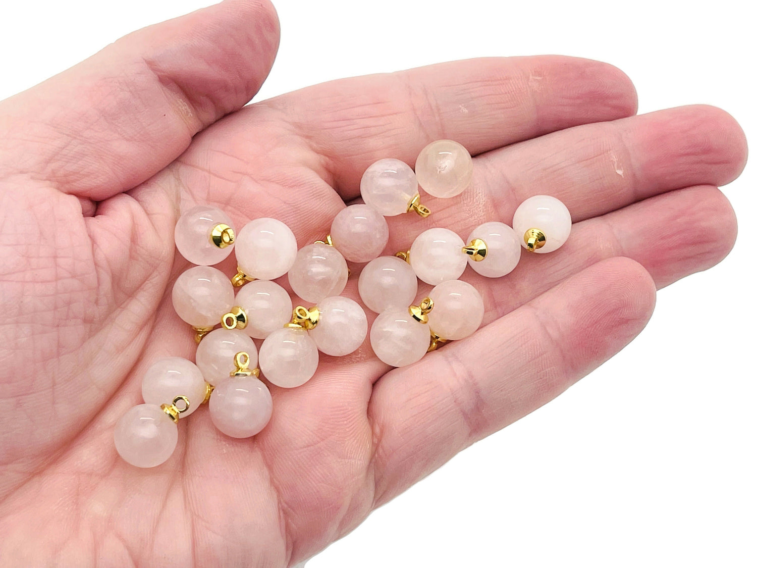 Rose quartz ball beads crystal pendant from GemstoneGO, showing smooth pink gemstone jewelry stone with silver clasp detail.
