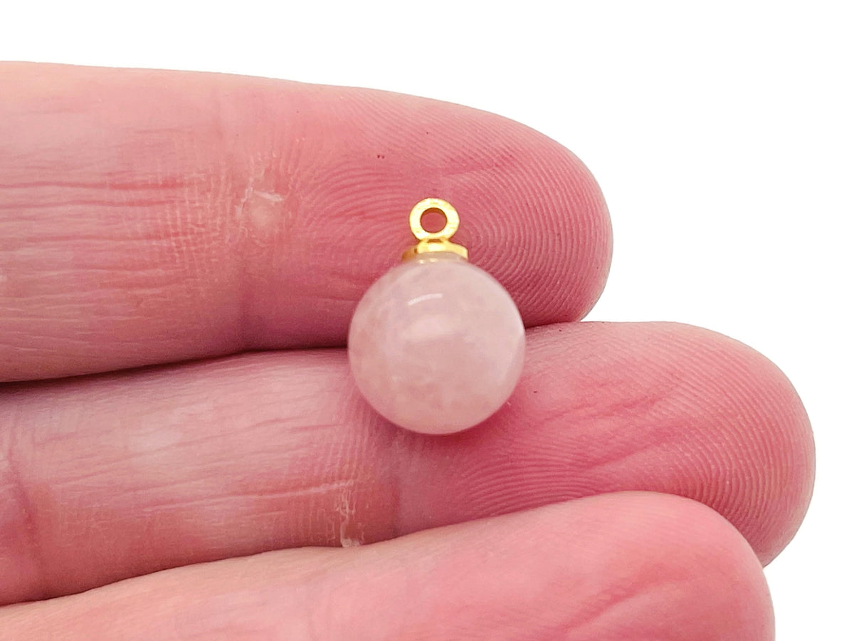 Rose quartz ball beads pendant with a gemstone crystal, showcasing a smooth, polished jewelry stone on a delicate string.