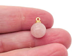 Rose quartz ball beads pendant with a gemstone crystal, showcasing a smooth, polished jewelry stone on a delicate string.