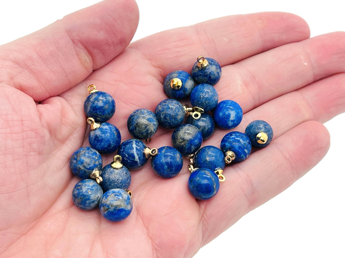 Lapis Lazuli ball beads with crystal pendant, showcasing deep blue stones with gold flecks, jewelry stone by GemstoneGO.