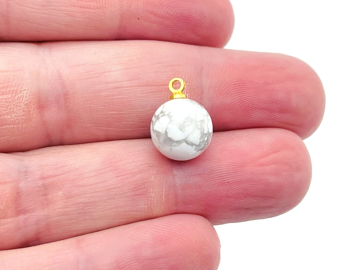 Howlite ball beads with crystal pendant, jewelry stone from GemstoneGO, showcasing smooth white and gray marbled gemstone beads.