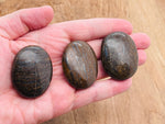 Bronzite palm gemstone spa stone, 45x35mm, from GemstoneGO, showing smooth, polished surface with natural bronze-brown color.
