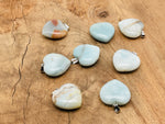 Amazonite heart crystal pendant from GemstoneGO, featuring a polished Reiki crystal with a silver bail on a black cord.