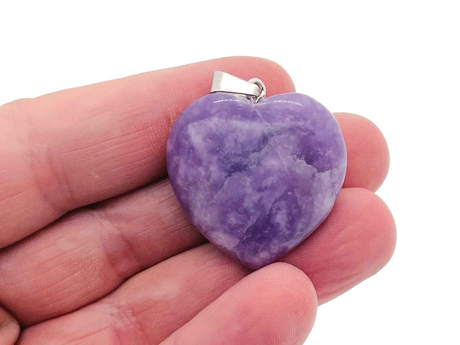 Lepidolite heart-shaped crystal pendant from GemstoneGO, showcasing a smooth, polished Reiki crystal with purple and silver tones.