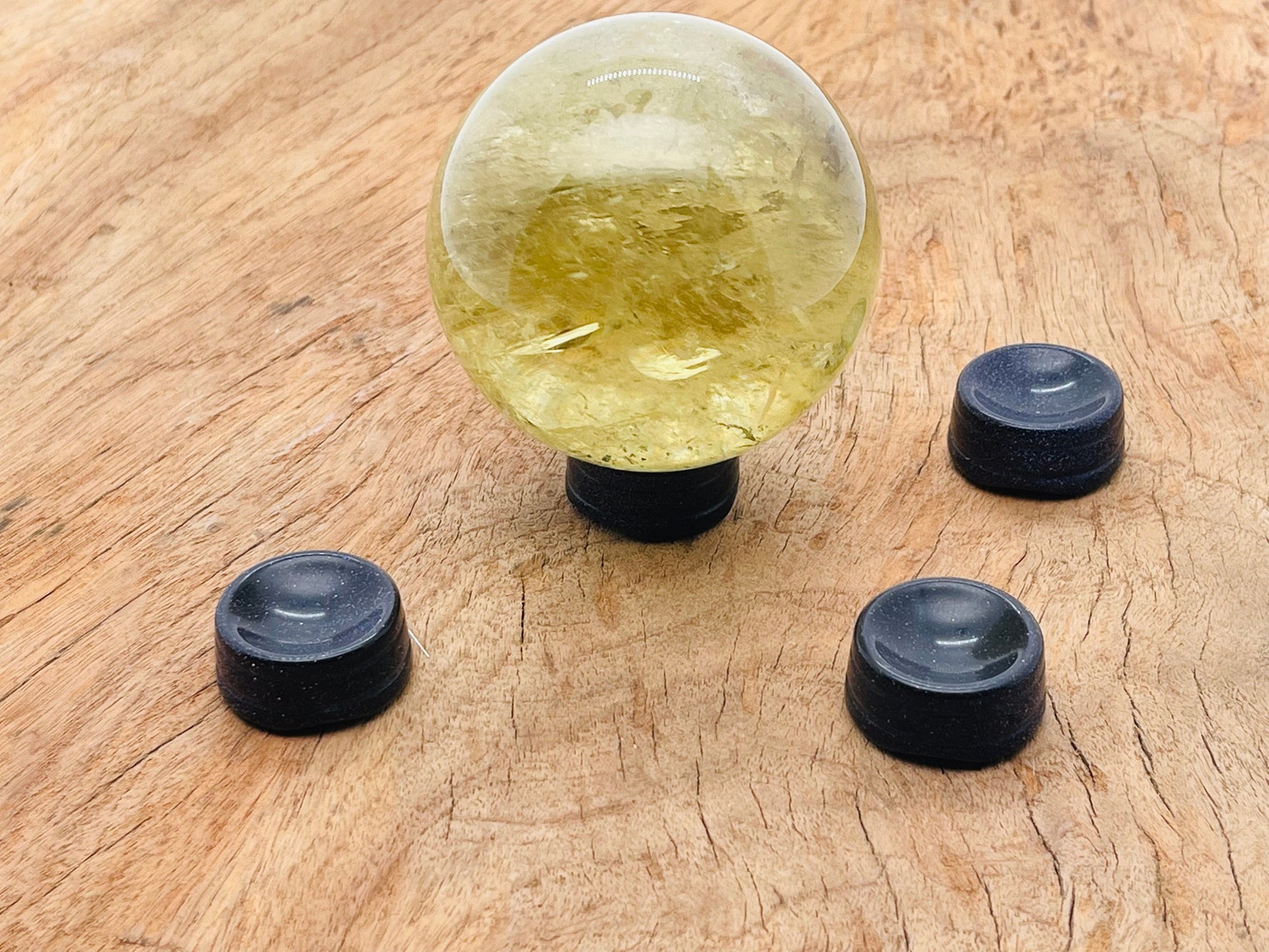 Blue GoldStone crystal sphere on a carved gemstone stand, perfect for home decor and display.