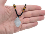 Aquamarine crystal necklace with a polished aquamarine stone on a silver chain, showcasing its healing gemstone qualities.