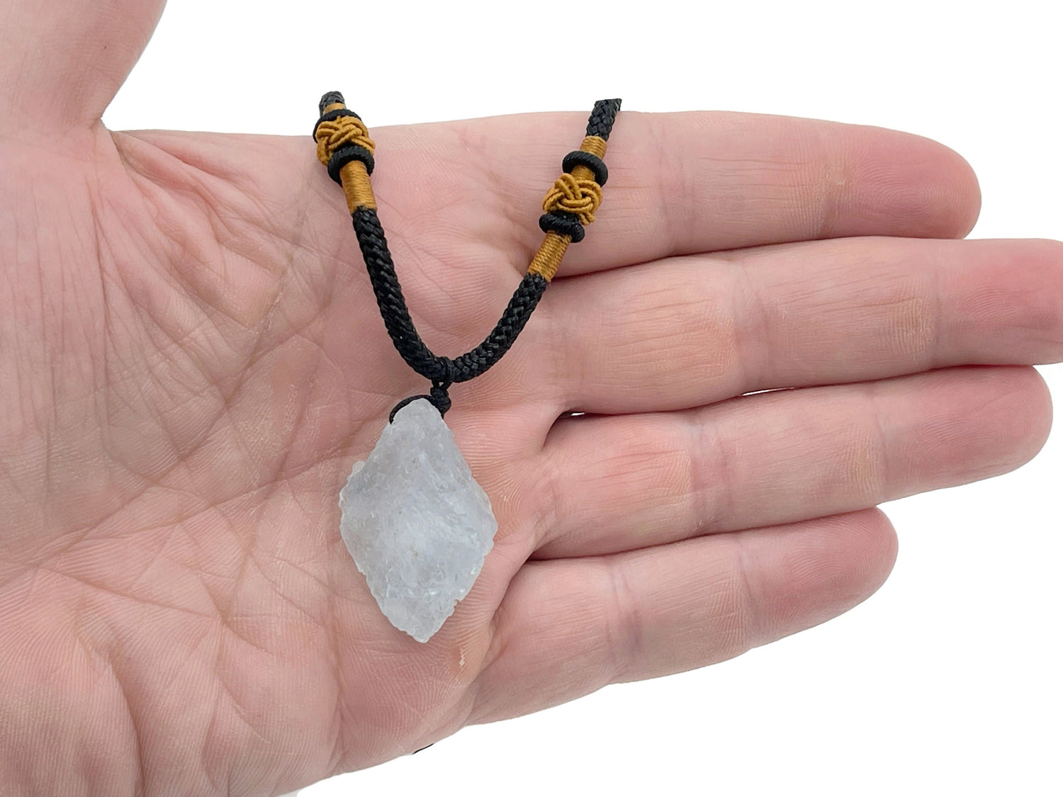 Aquamarine crystal necklace with a polished aquamarine stone on a silver chain, showcasing its healing gemstone qualities.
