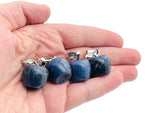 Mini Sodalite apple crystal pendant from GemstoneGO featuring a polished blue gemstone pendant on a silver chain.