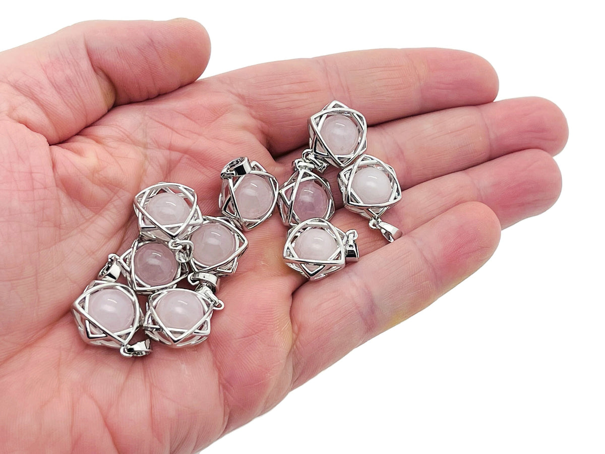 Rose quartz crystal pendant necklace from GemstoneGO featuring a polished pink gemstone on a silver chain.