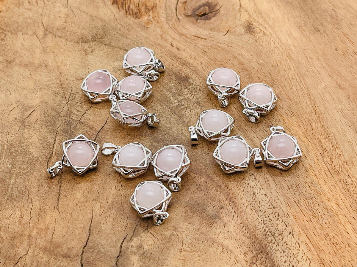 Rose Quartz crystal pendant jewelry by GemstoneGO, featuring a polished pink gemstone on a silver chain.
