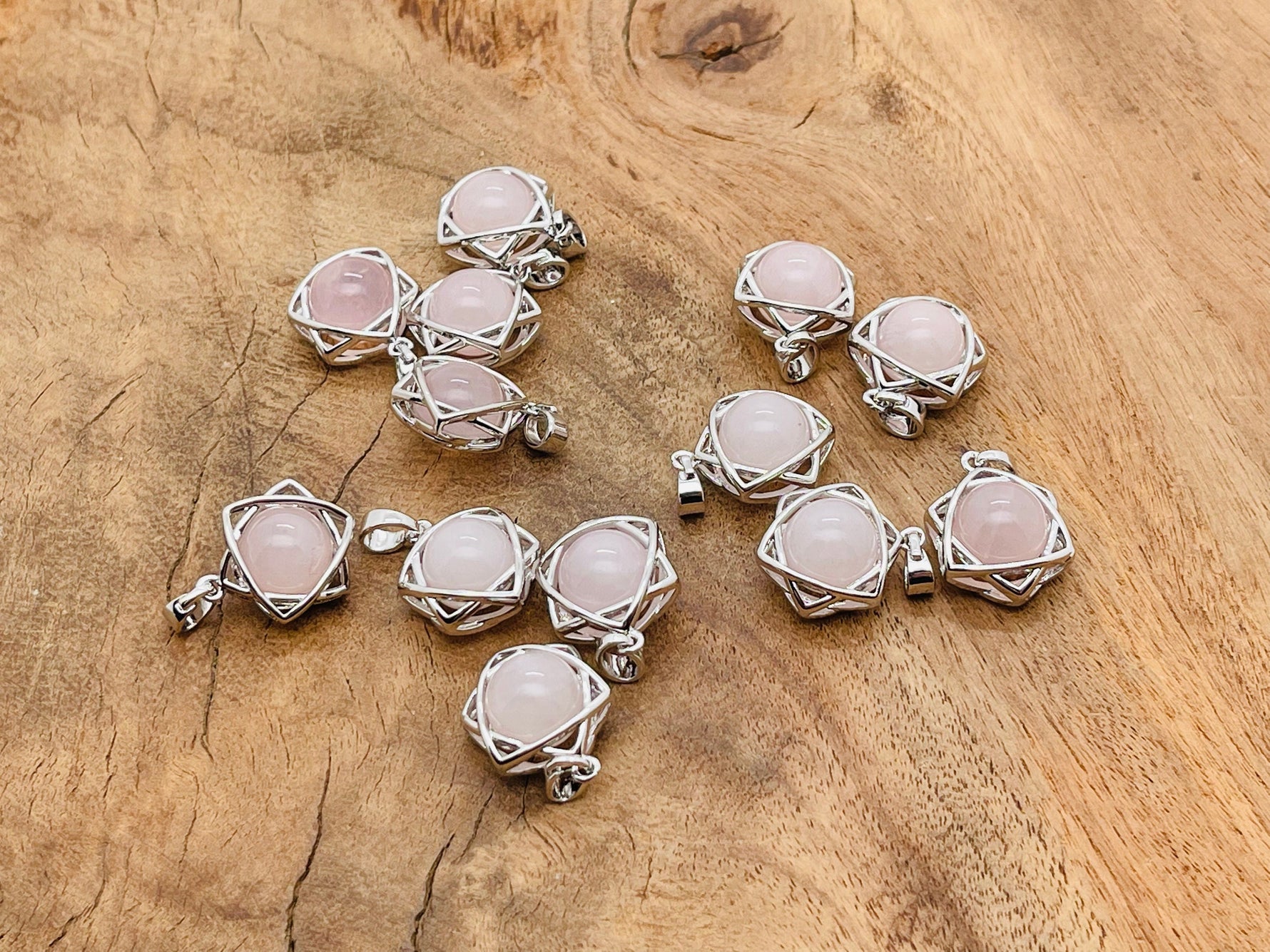Rose Quartz crystal pendant jewelry by GemstoneGO, featuring a polished pink gemstone on a silver chain.
