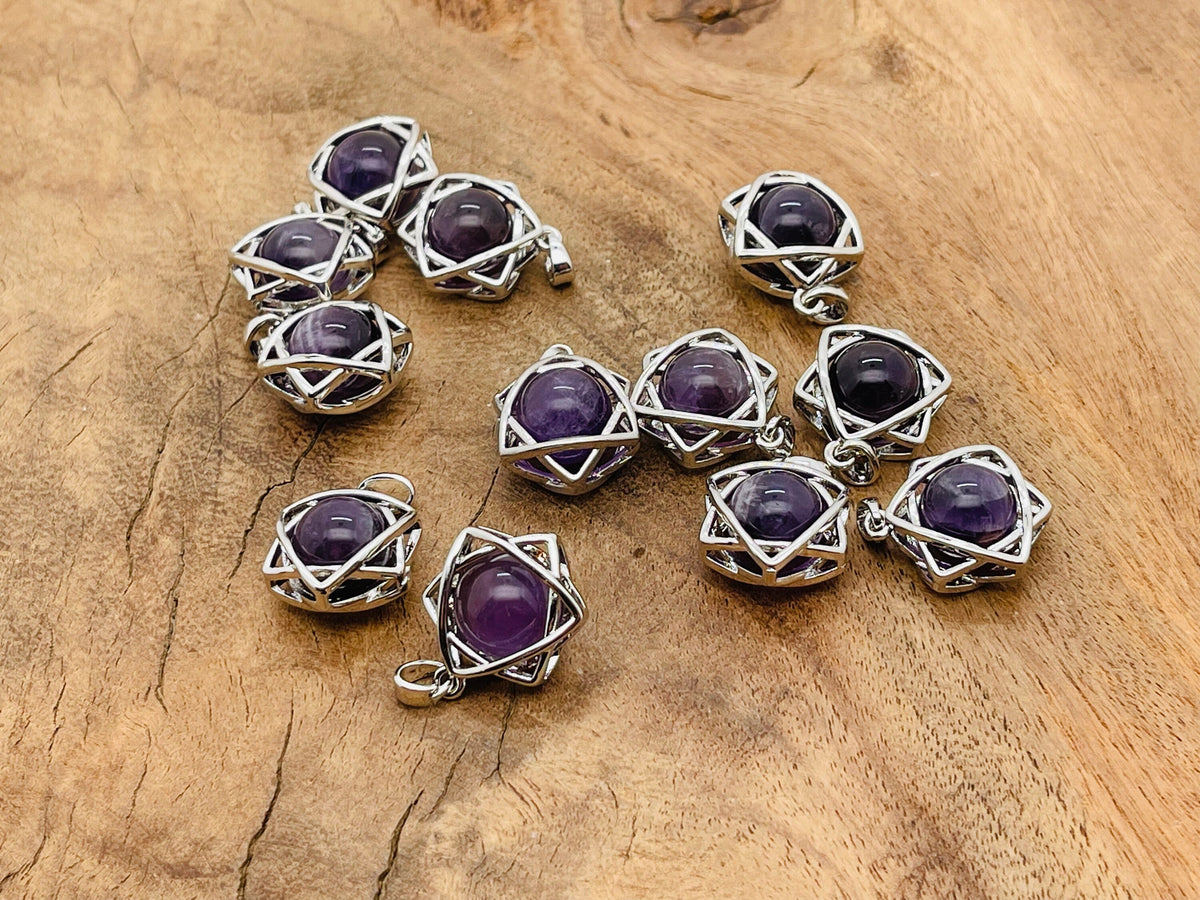 Amethyst crystal pendant necklace from GemstoneGO featuring a polished purple gemstone on a silver chain.
