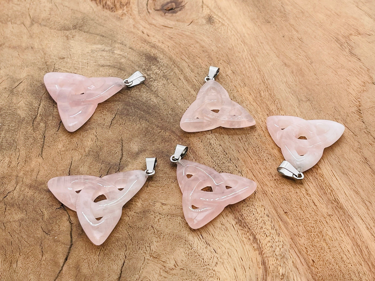 Rose quartz Celtic knot crystal pendant from GemstoneGO featuring a Trinity Crystals design on a silver chain.