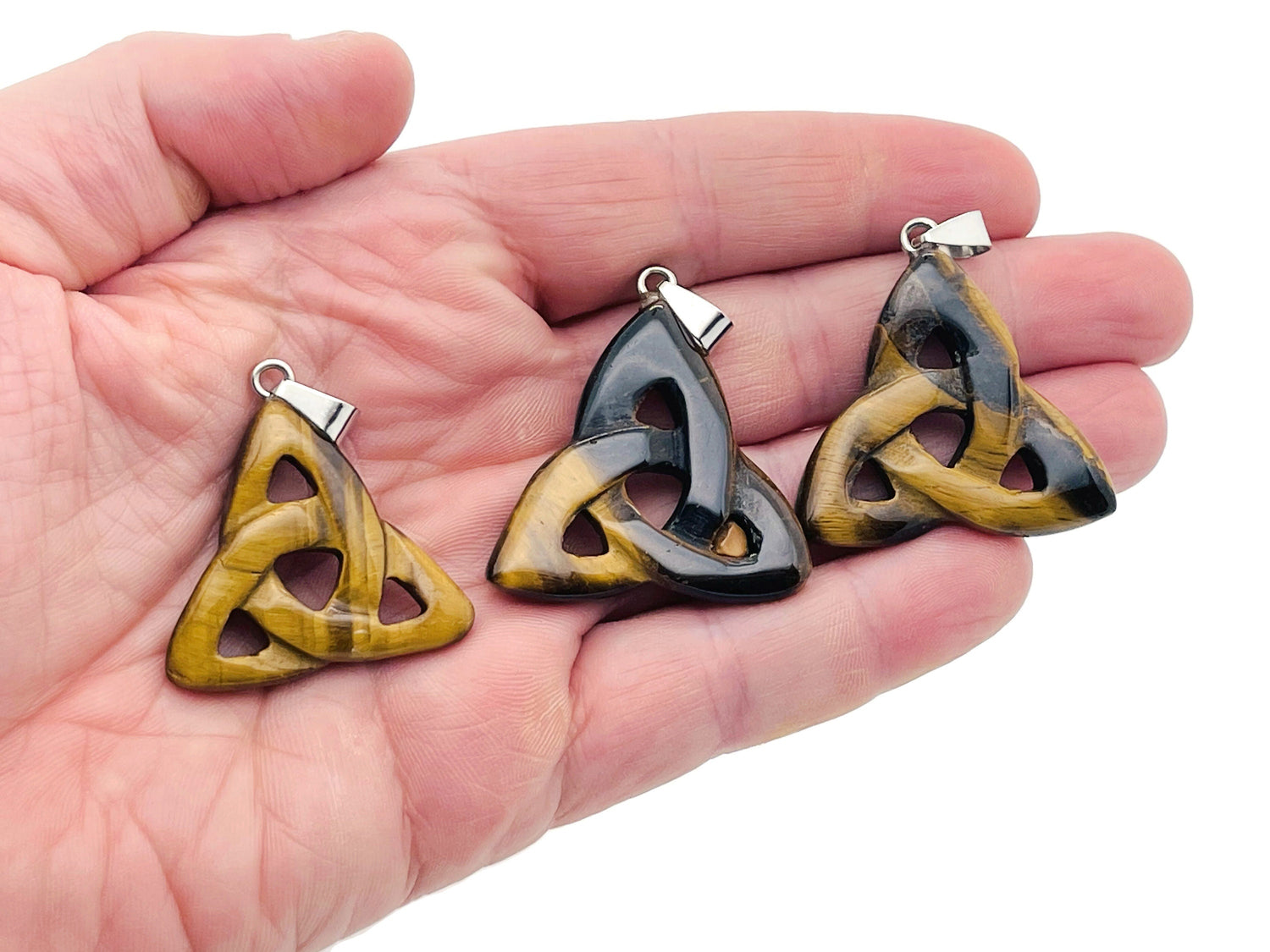 Tiger Eye Celtic Knot crystal pendant featuring Trinity Crystals from GemstoneGO, showcasing intricate knot design and polished stone.