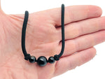 Obsidian sphere crystal pendant necklace with black cord, featuring a polished black obsidian stone for healing and protection.