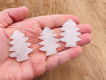 Handmade clear quartz pine tree gemstone carving with detailed tree design, showcasing natural stone texture and craftsmanship.