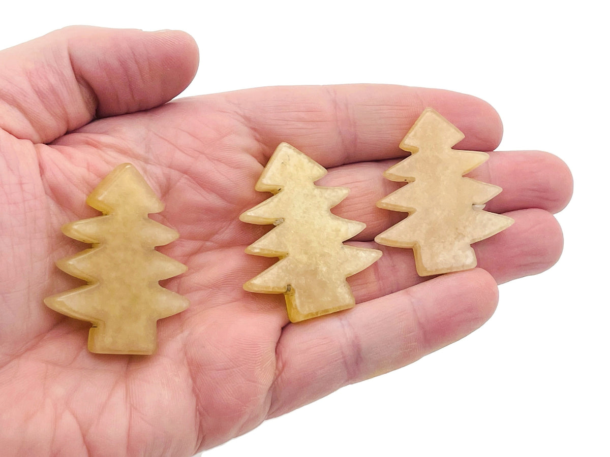 Handmade yellow aventurine gemstone carven pine tree sculpture, detailed natural stone tree for decorative display.