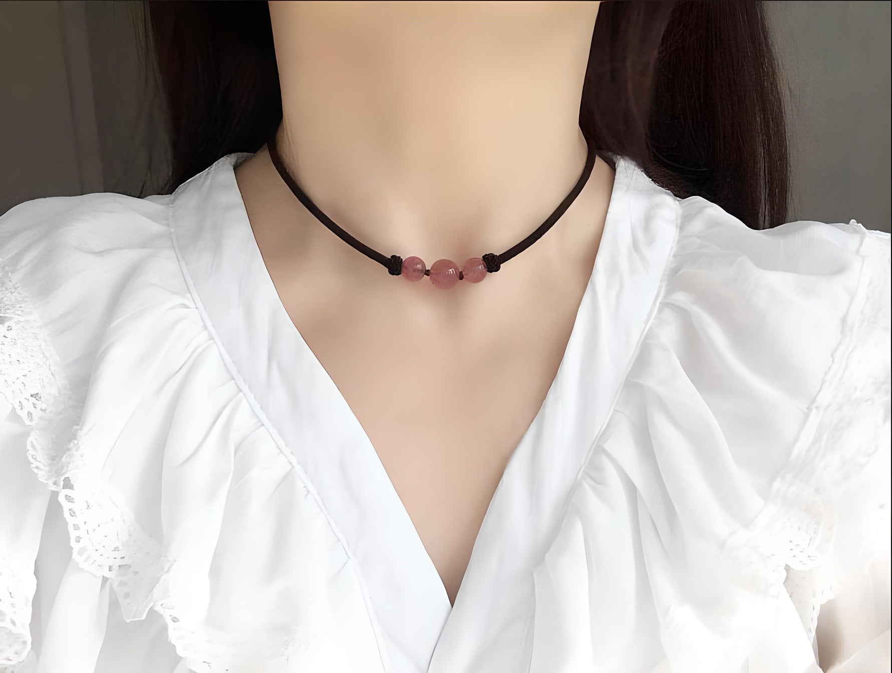 Strawberry quartz sphere crystal necklace with a polished, round gemstone pendant on a delicate chain, showcasing vibrant pink tones.