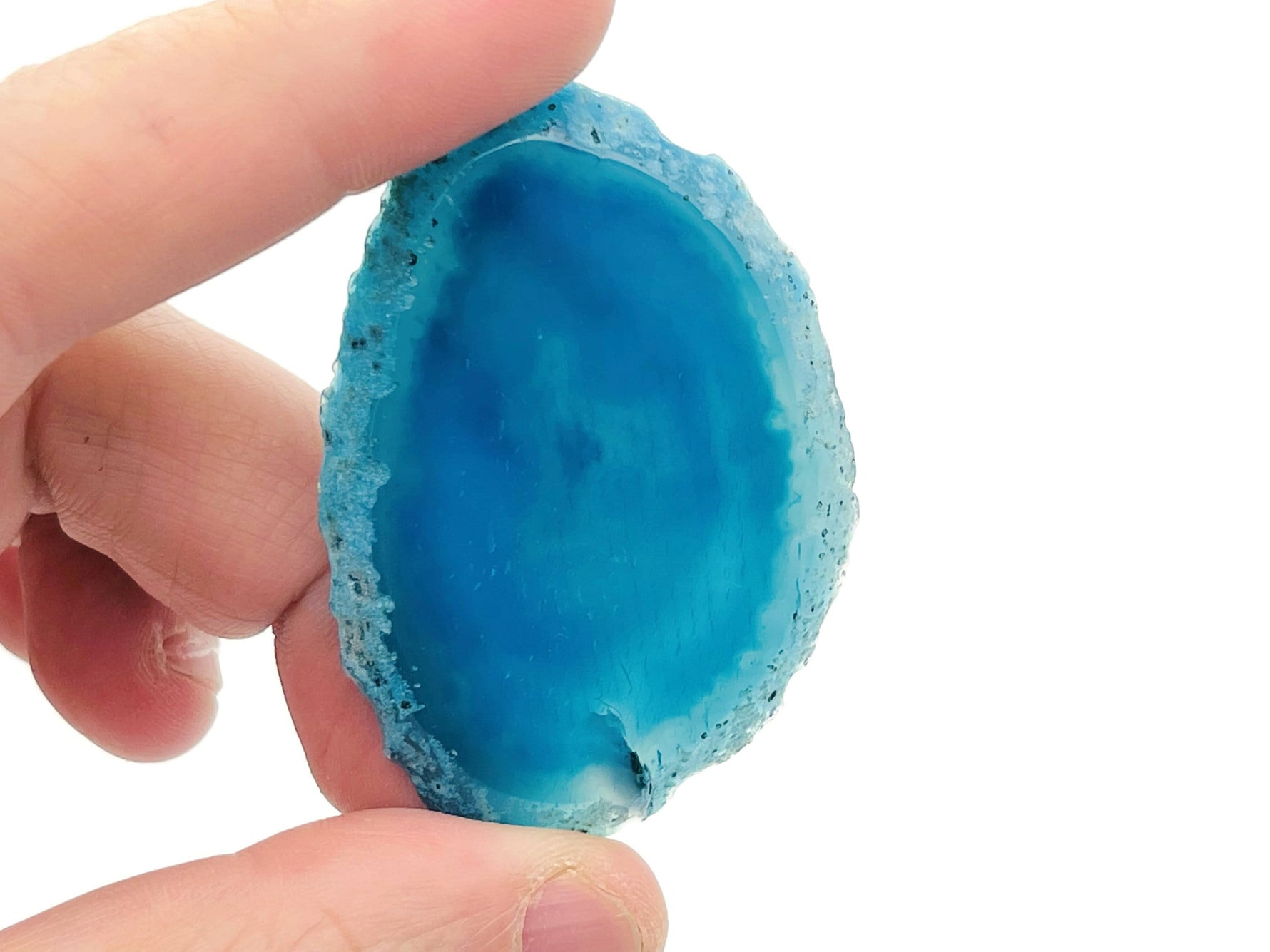 Blue agate geode slice gemstone with raw crystal interior, showcasing vibrant blue hues and natural crystal formations.