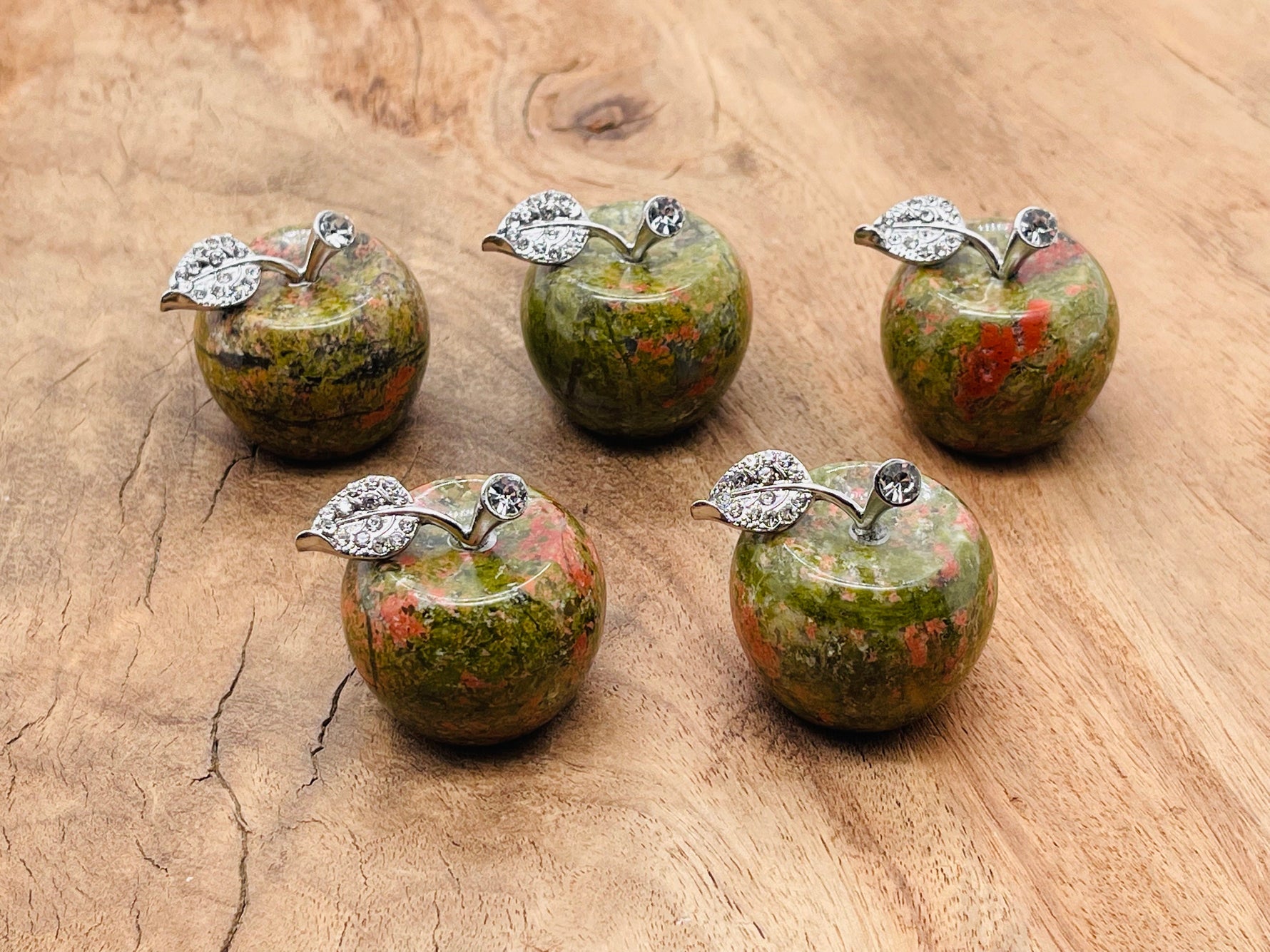 Unakite apple-shaped crystal carving by GemstoneGO, 30mm, featuring vibrant green and pink gemstone details.