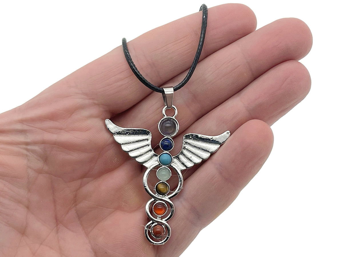 Angel wing crystal necklace with seven stones from GemstoneGO featuring a delicate silver chain and sparkling angel wing pendant.