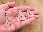 Rose quartz Celtic knot crystal pendant featuring Trinity Crystals by GemstoneGO, showcasing a detailed carved design on a silver chain.